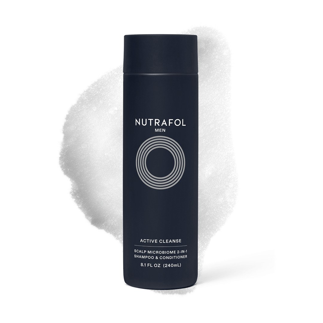 Nutrafol — Men Active Cleanse two-in-one bottle against a foam texture