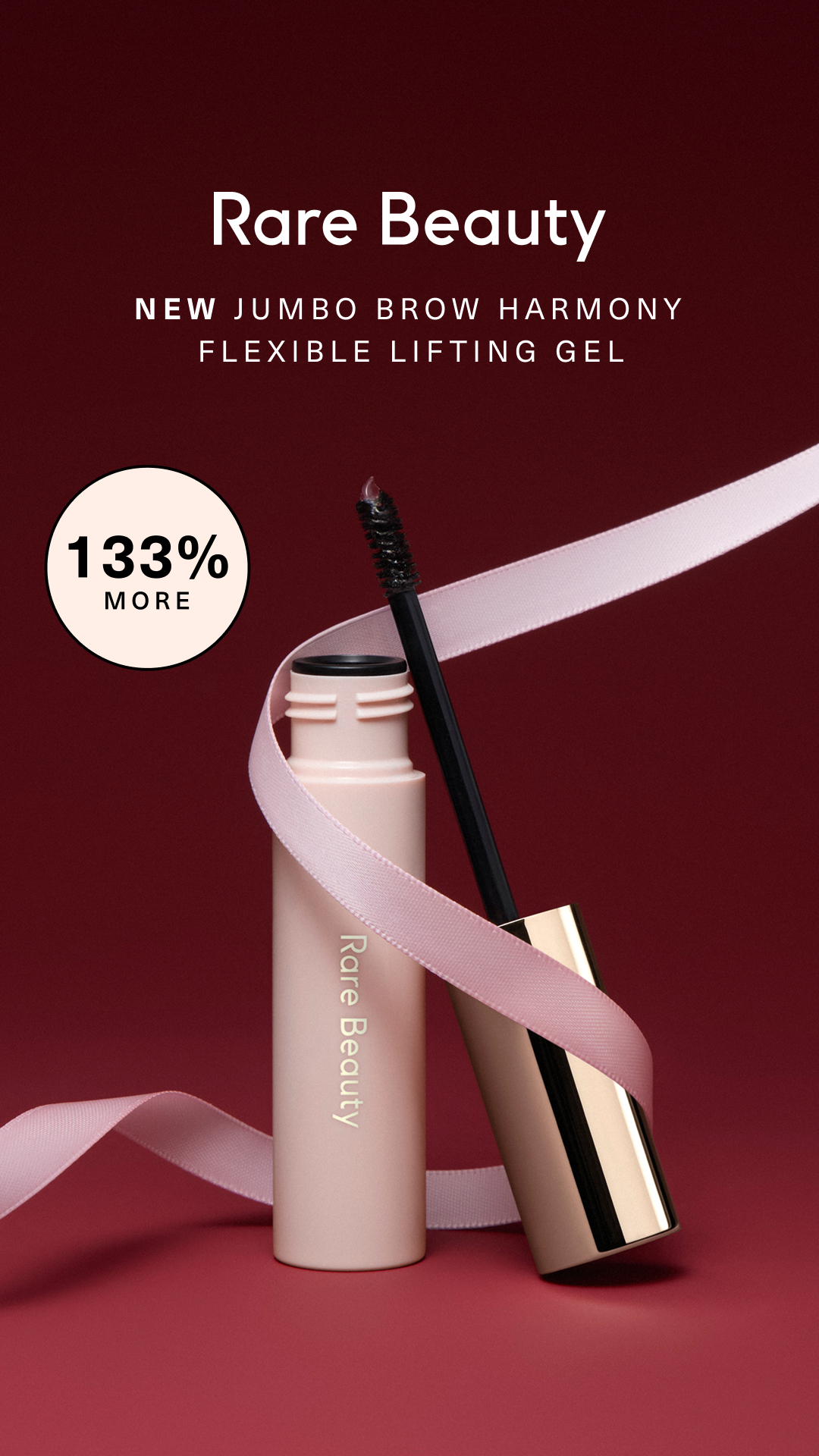 Rare Beauty — Jumbo Brow Harmony gel wrapped in ribbon against burgundy