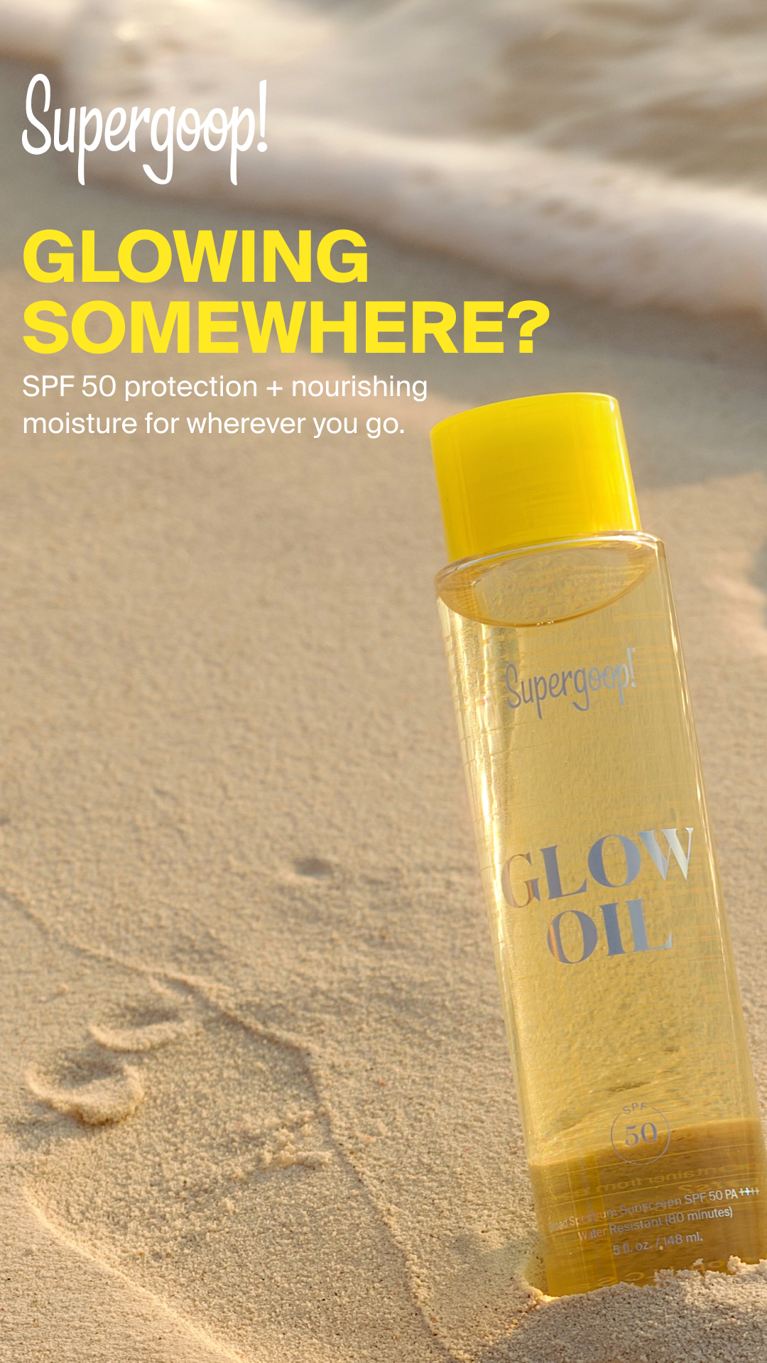 Supergoop! — Glow Oil sunscreen bottle on beach sand