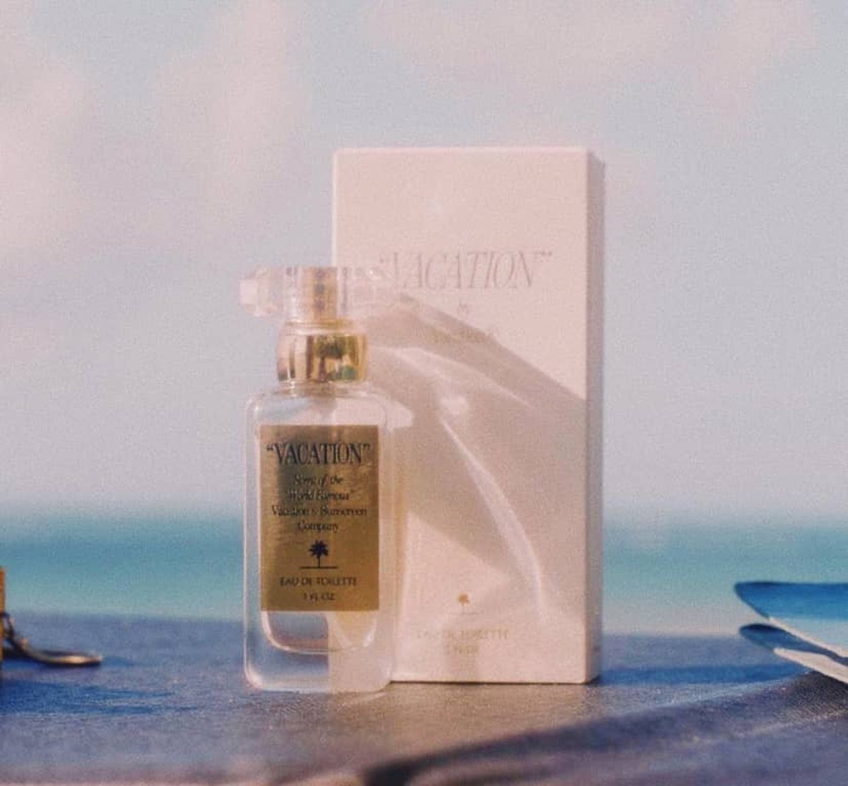 Vacation’s signature fragrance and box on a beach table