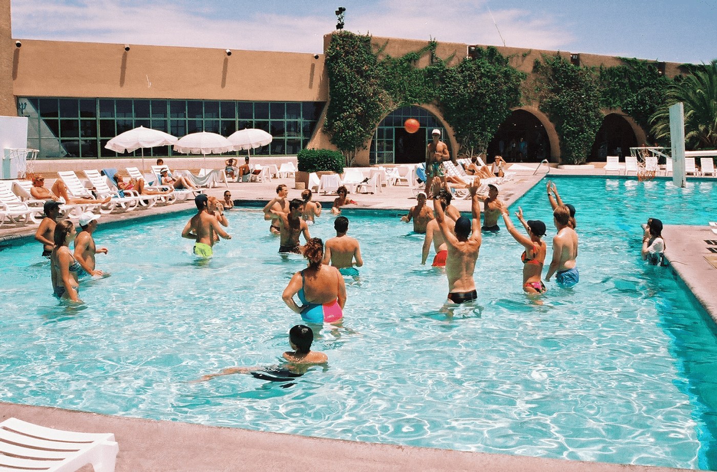 A poolside basketball game in Vacation’s resort photography